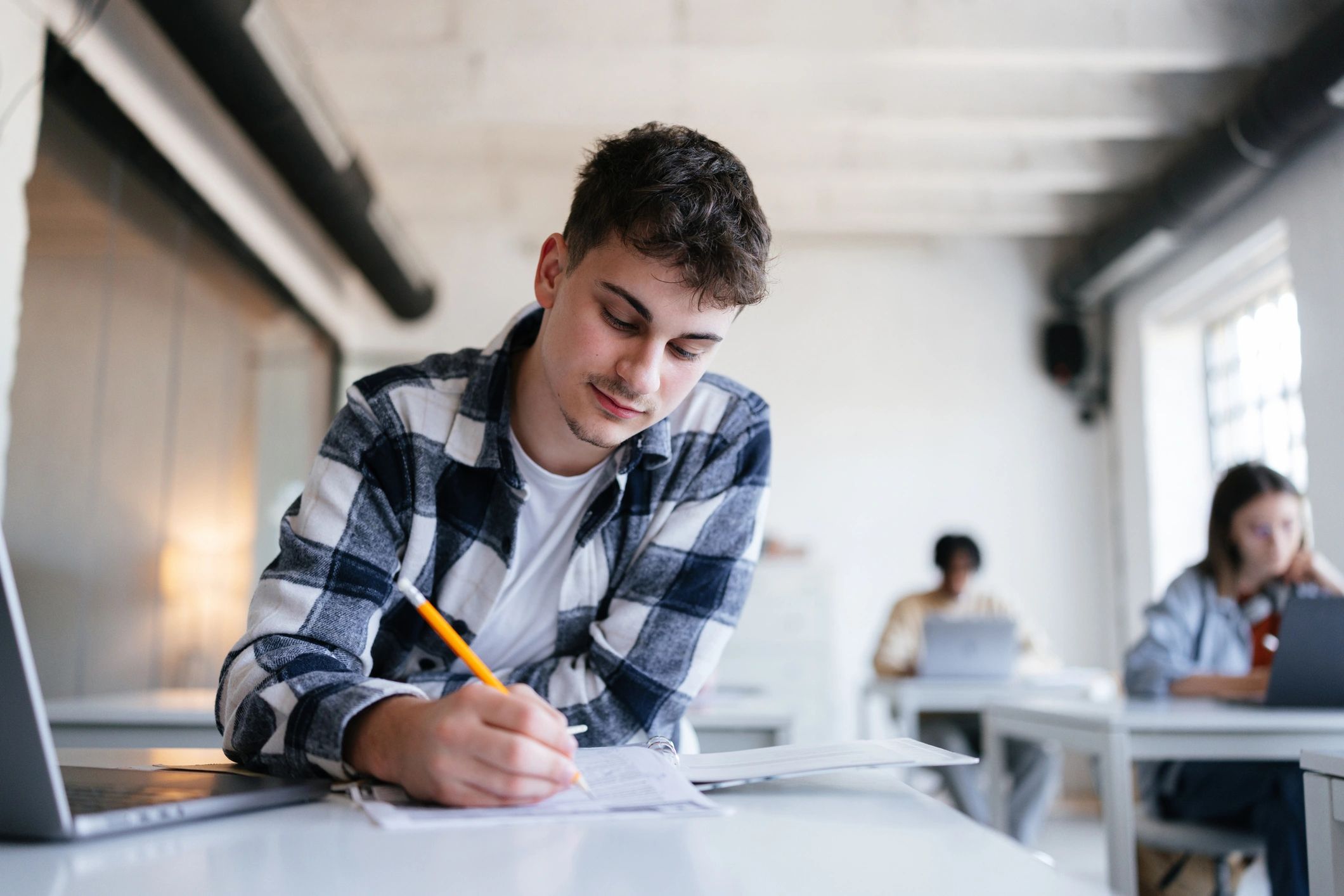 student taking exam classroom